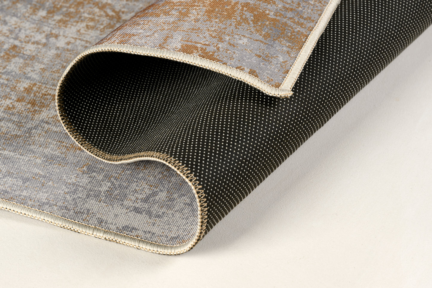 Roll of textured rug material on a light background