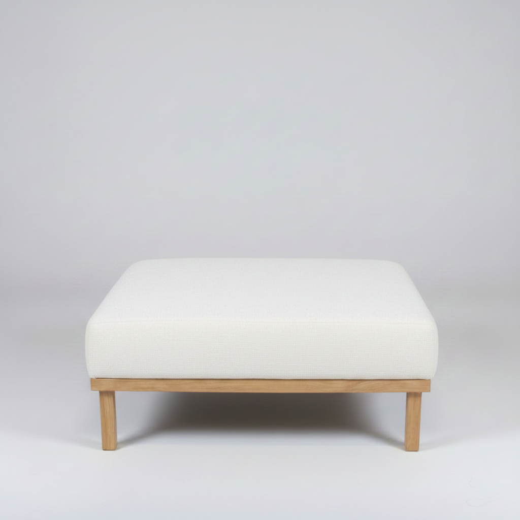 White ottoman with wooden legs on a light gray background