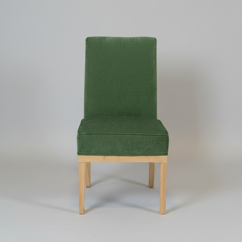 Green upholstered chair with wooden legs on a plain background