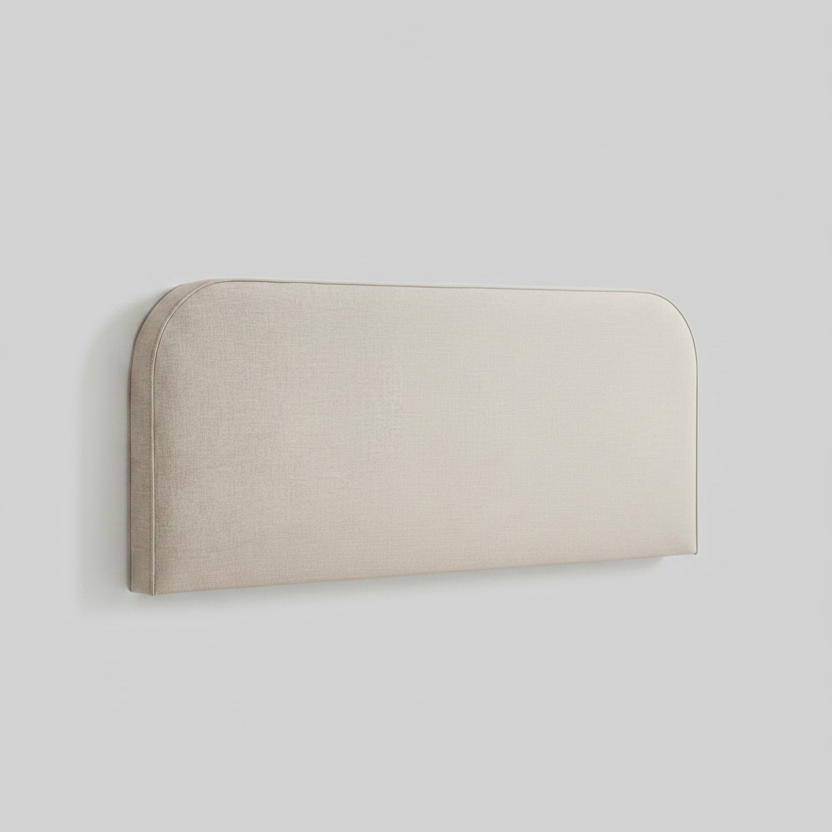 Beige upholstered headboard with a white pillow on a light gray background