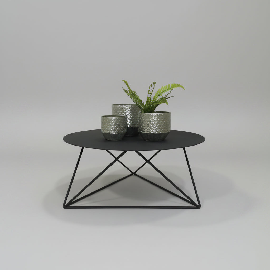 Elements Coffee Table with round black steel top and geometric frame.