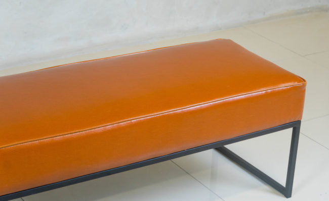 Steel Frame Ottoman with black epoxy base and upholstered top.