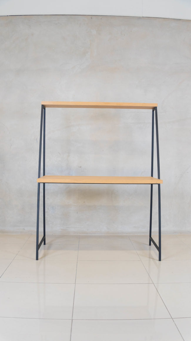 Milly Desk in a home office, featuring a sleek design with a top shelf for decor and essentials.