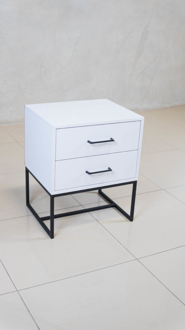 Modern white melamine bedside table with two spacious drawers and black handles.
