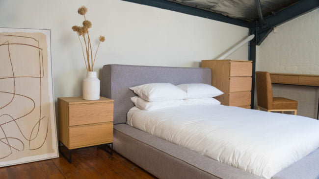 Bold Bed with plush upholstery and a modern, bulky design for contemporary bedrooms.