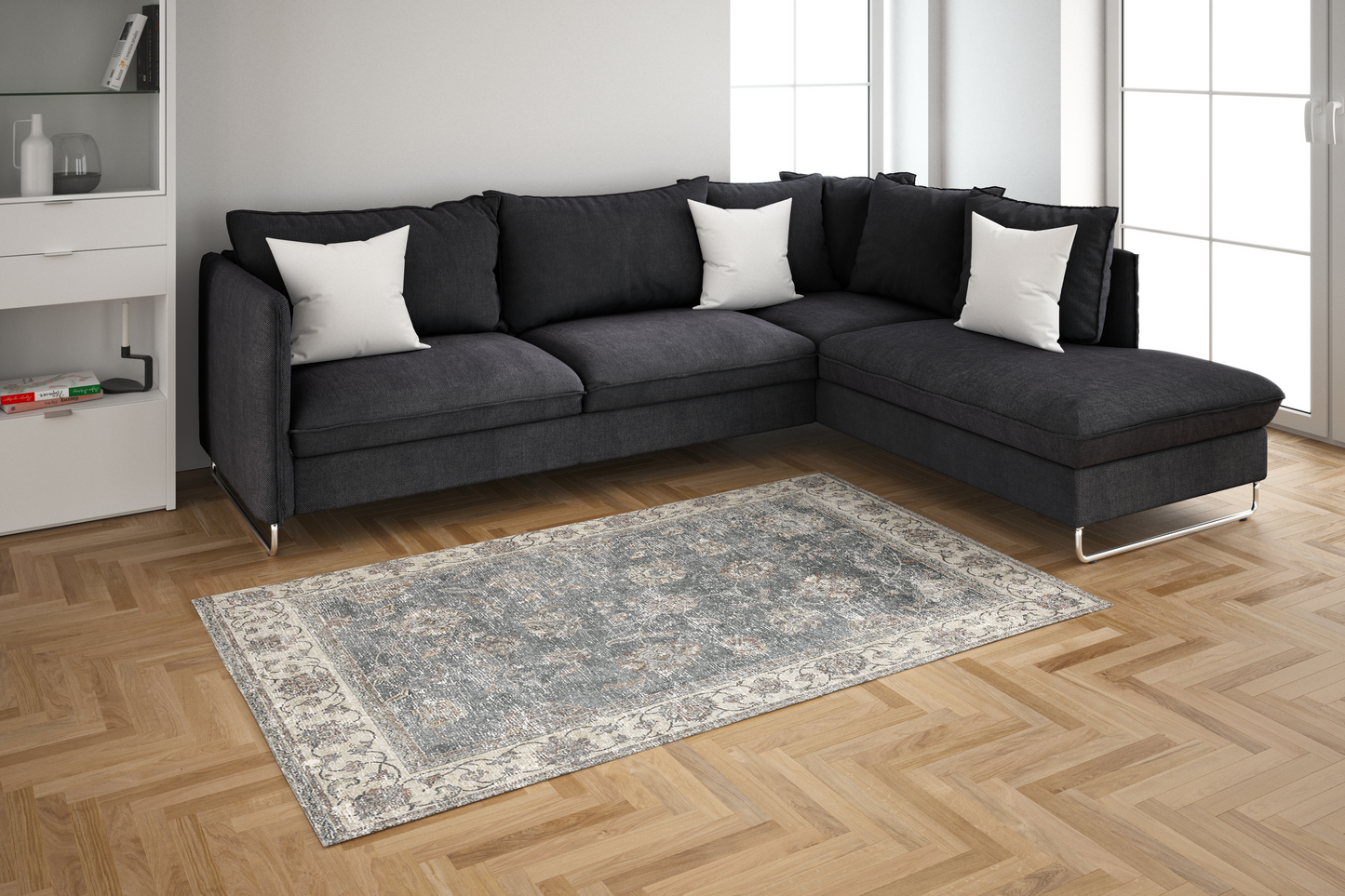 Gray sectional sofa with white pillows on a wooden floor in a living room setting.