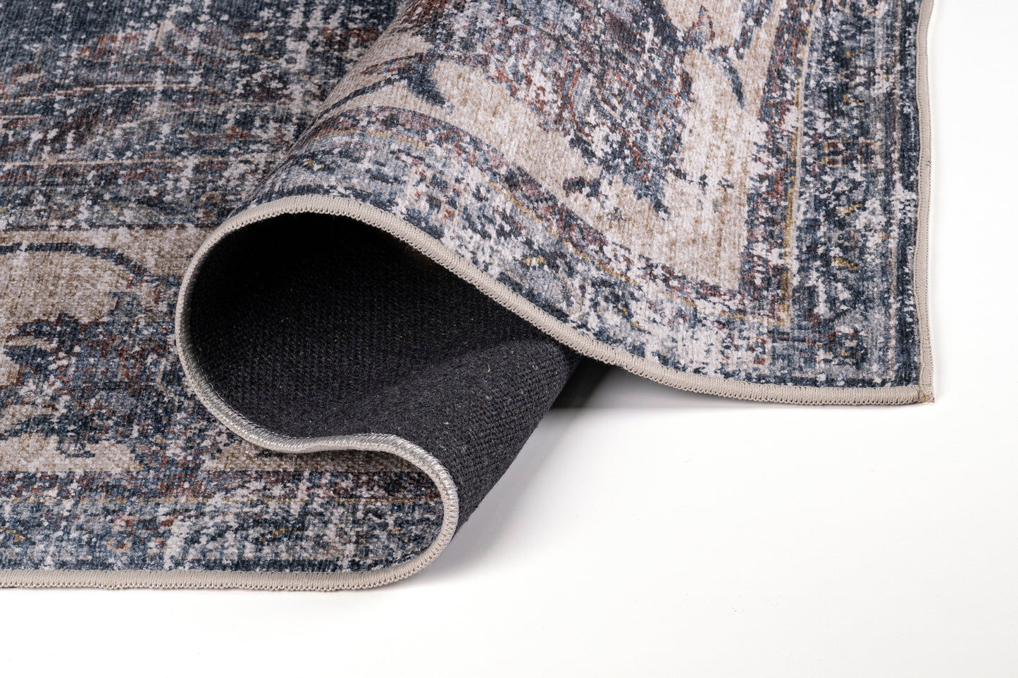 Close-up of a textured rug corner on a white background