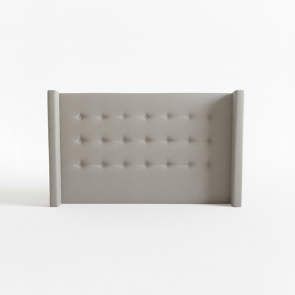Gray tufted headboard on a white background