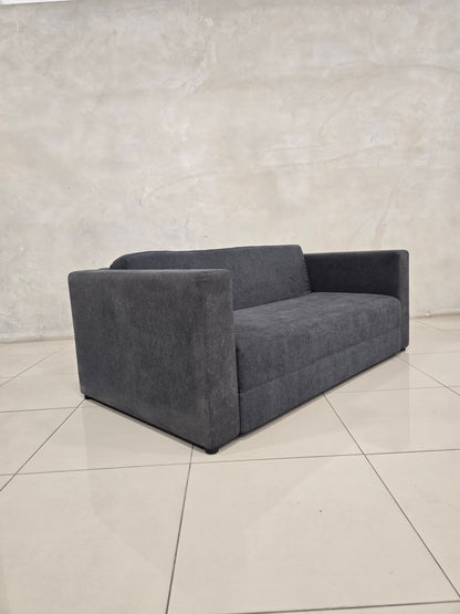 Modern couch that converts to bed, with sleek minimalist design.