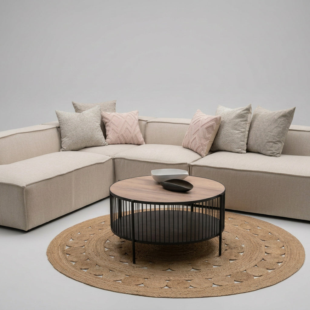 Modern living room with a sectional sofa, coffee table, and decorative items.