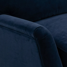 A modern two-seater loveseat sofa upholstered in deep navy blue velvet, featuring slim metallic legs, photographed on a seamless light gray studio background.