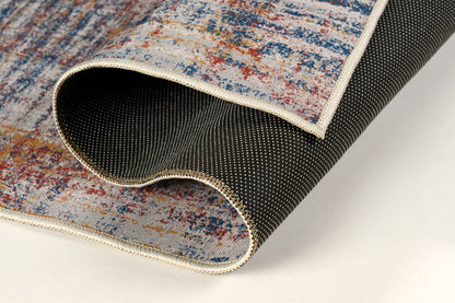 Close-up of a textured rug with a colorful pattern on a light background