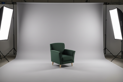 Green armchair on a white background with studio lighting equipment.