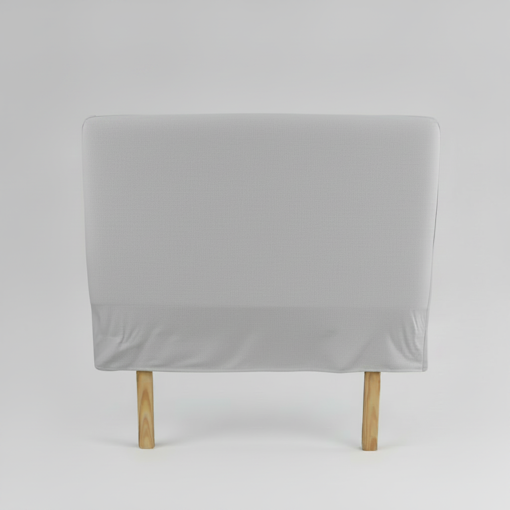Gray slipcover headboard on a wooden chair against a grey background