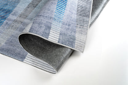 Gray and blue patterned rug on a white background