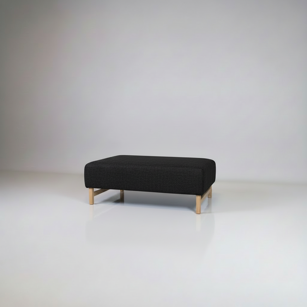 Black ottoman with wooden legs on a white background