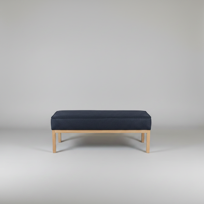Navy bench with wooden legs on a plain background