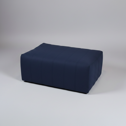 White wedge-shaped ottoman on a gray background