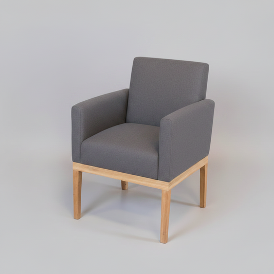 Gray armchair with wooden legs on a light gray background