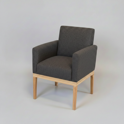 Gray upholstered armchair with wooden legs on a light gray background