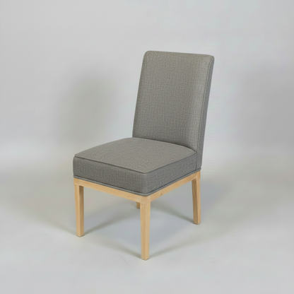 Gray upholstered chair with wooden legs on a light gray background