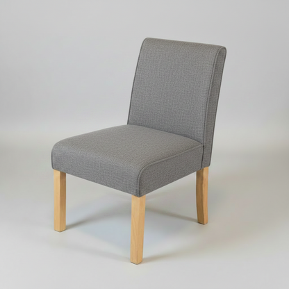Gray upholstered chair with wooden legs on a light gray background