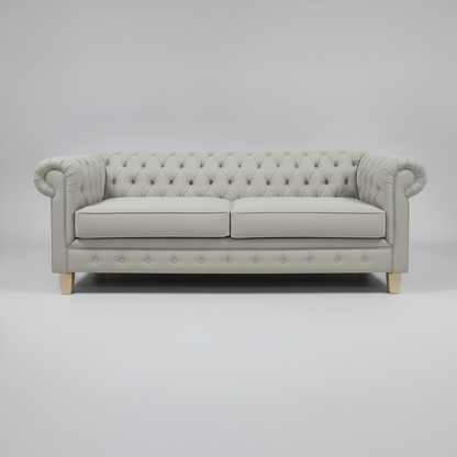 Gray tufted sofa on a gray background