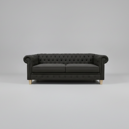 Dark gray sofa with tufted backrest on a light gray background