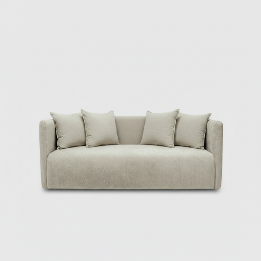 Beige sofa with four cushions on a light gray background