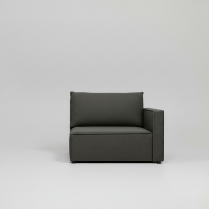 Gray fabric armchair with a pillow on a light gray background