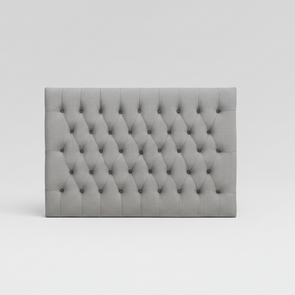 Gray tufted headboard on a white background