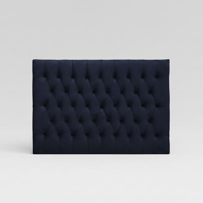 Navy tufted headboard on a light gray background