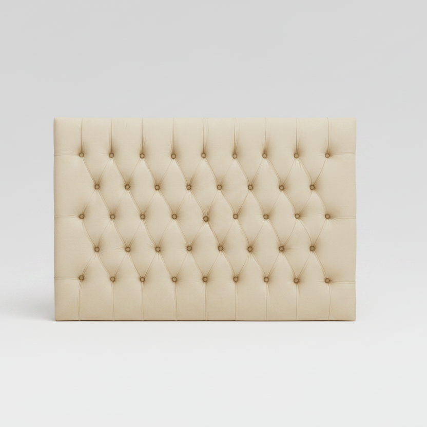 Beige tufted headboard on a white background