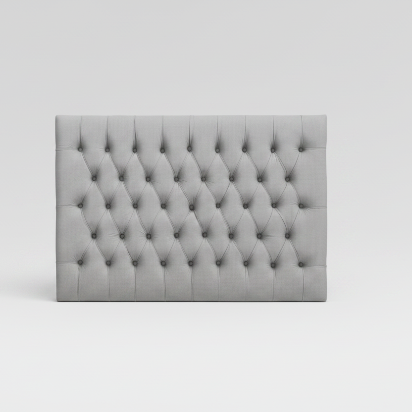 Gray tufted headboard on a white background