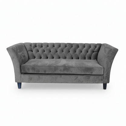 Gray tufted sofa on a white background
