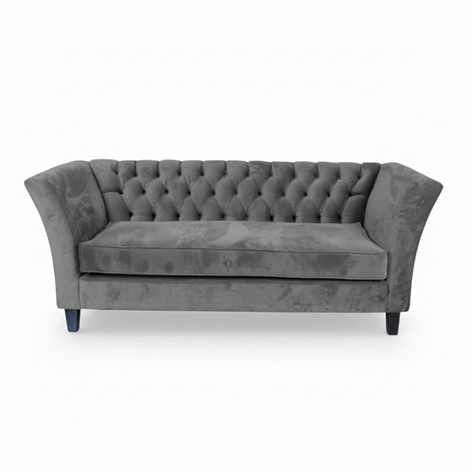 Gray tufted sofa on a white background