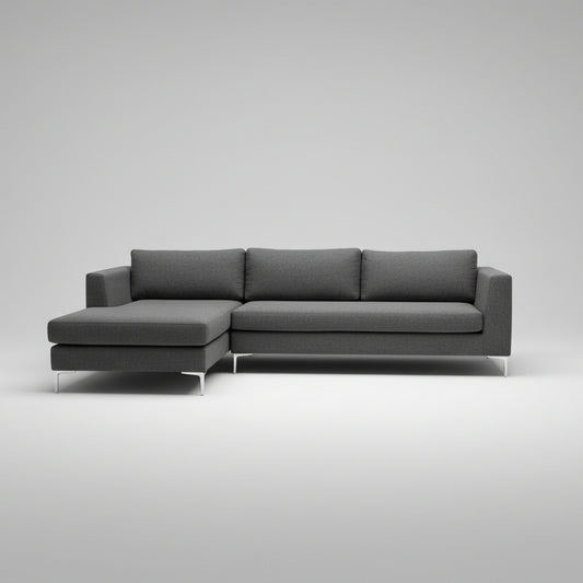 A modern gray fabric sectional sofa with a chaise lounge on the left, photographed in a furniture showroom.