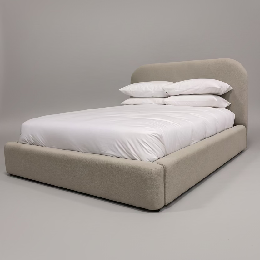Beige bed with white bedding against a gray background