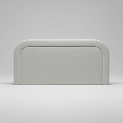 Gray upholstered headboard on a white bed frame against a light gray background