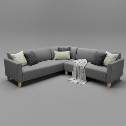 A modern L-shaped gray fabric sectional sofa with light wood legs, styled with cream and dark gray throw pillows and a white knit blanket, set against a solid gray studio background.