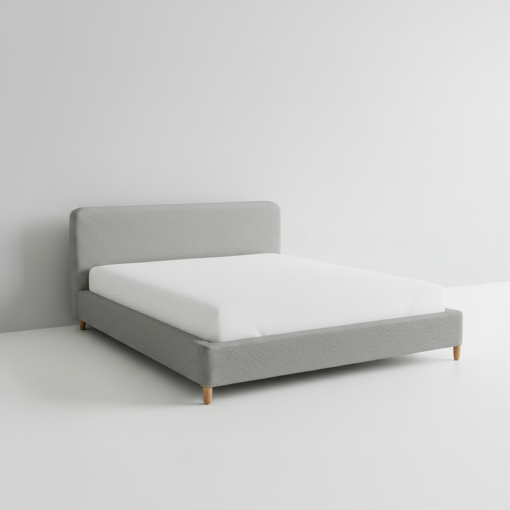 White bed with a white mattress on a plain background
