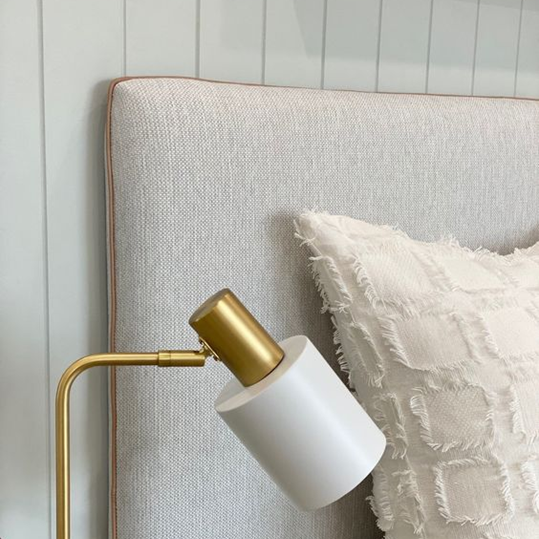Close-up of a textured headboard against a light-colored wall.