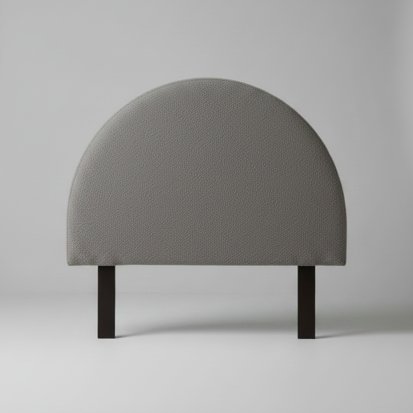 Gray upholstered headboard on a plain background