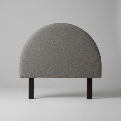 Gray upholstered headboard on a plain background