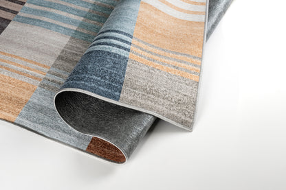 Close-up of a patterned rug with brown, blue, and gray colors on a white background.