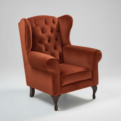 Mustard yellow wingback chair on a white background
