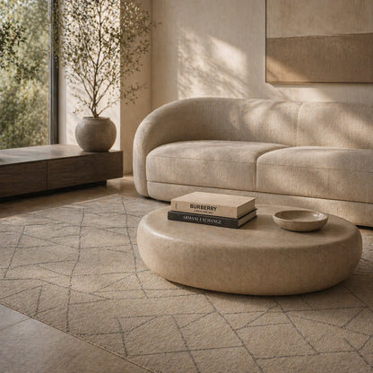 Modern living room with a beige sofa and round coffee table.
