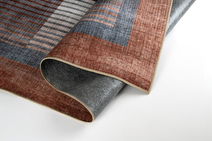 Patterned rug with brown, blue, and gray colors on a white background