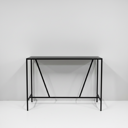 Black metal console table against a white wall