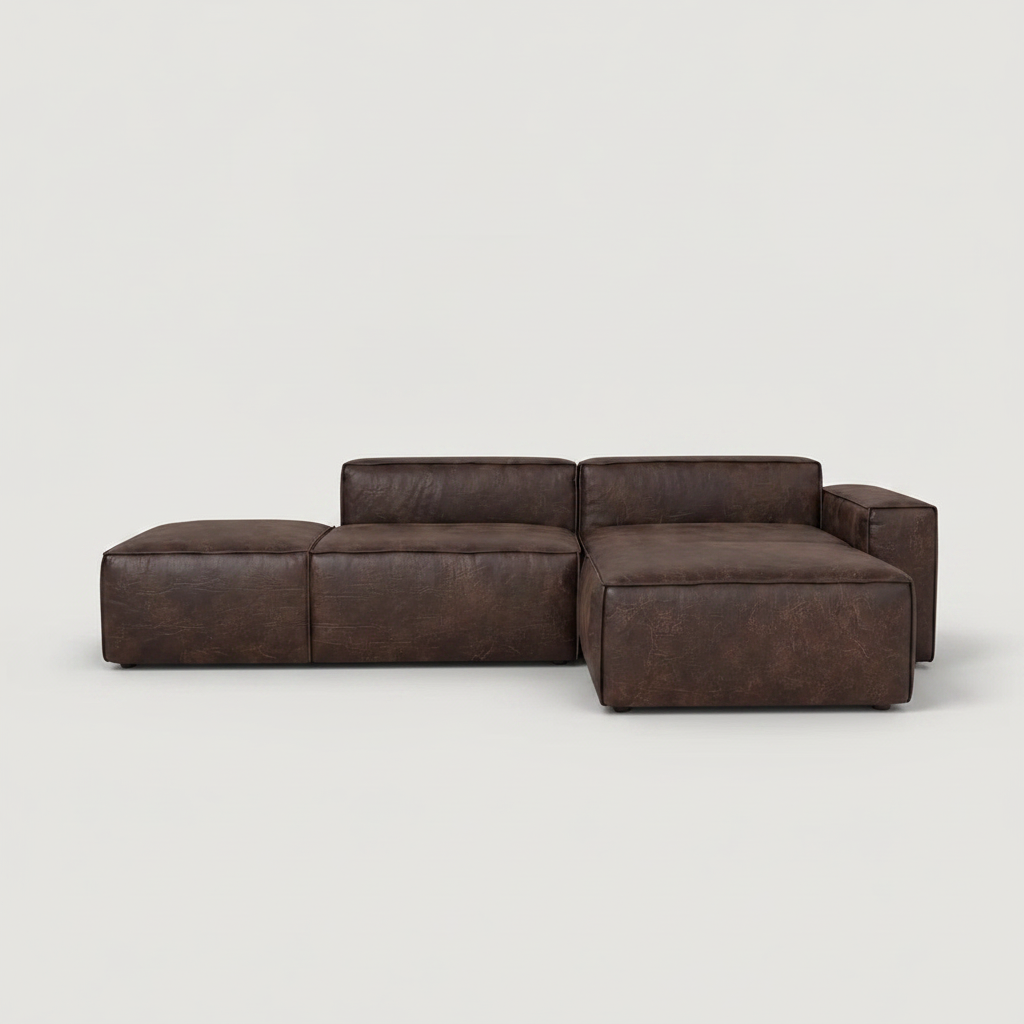 A dark brown modular sectional sofa with a chaise lounge on the left, shown against a plain light gray studio background.